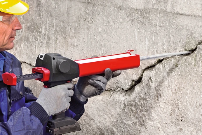 Man using tool on a brick wall
